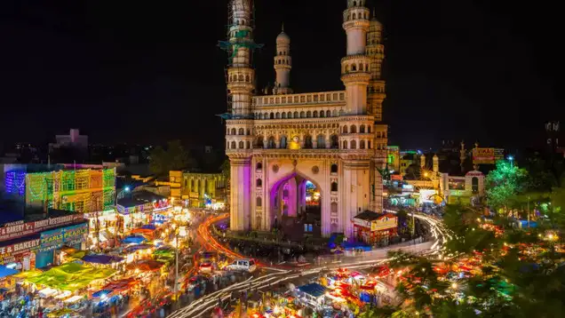 a large building with towers and a crowd of people around it